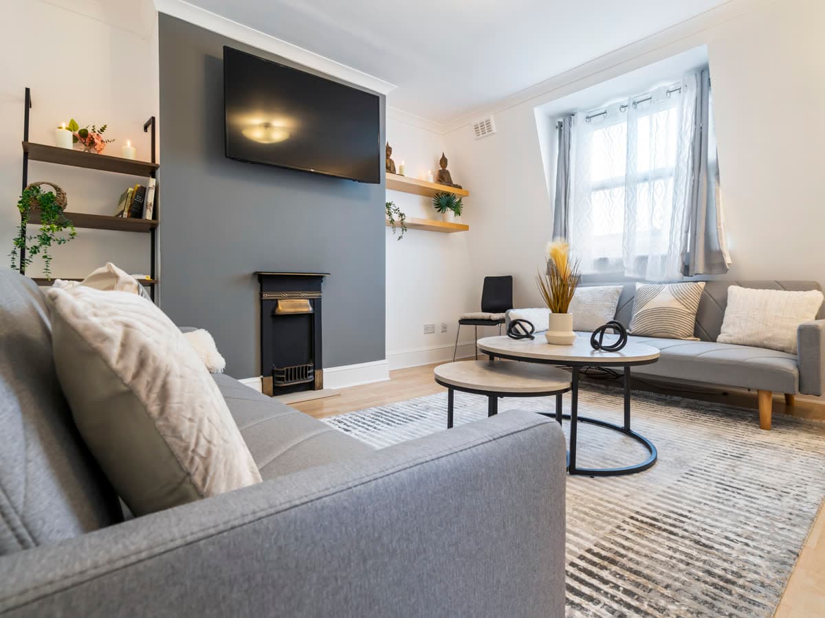 Living room with a period fireplace in one of the apartments we operate