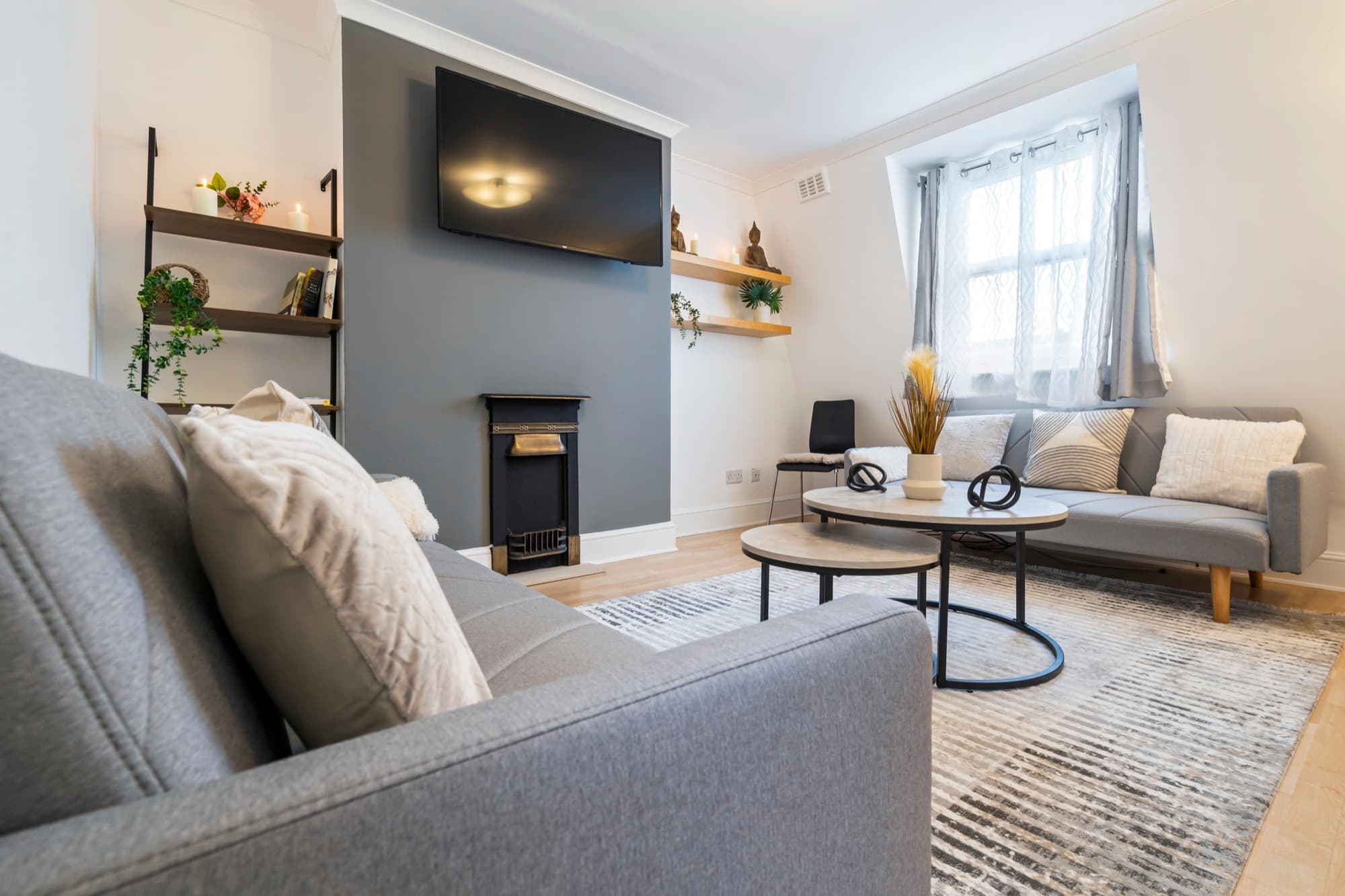 Relaxed living room with a period fireplace in one of our apartments